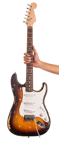 Photograph of someone holding an electric guitar.