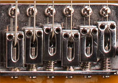 Closeup detail of guitar, at original scale